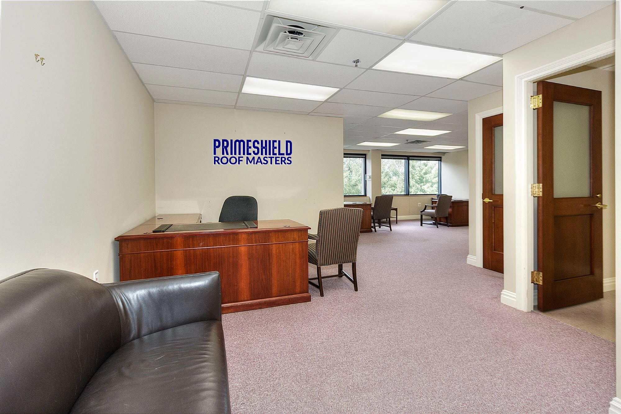 Primeshield Roof Masters office interior with company logo and branding on wall